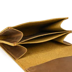 Detail view of the interior compartments of a vintage brown crazy horse leather coin purse.