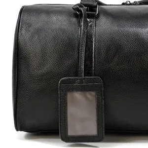 Black leather travel duffel bag detail, premium cowhide luggage for men business trips.