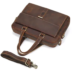 Close-up detail shot of the brown crazy horse leather briefcase with shoulder strap and metal hardware.