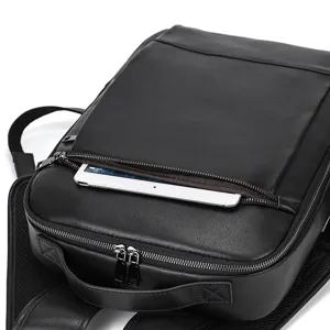 Black leather business backpack detail shot showcasing smooth zipper and tablet pocket storage.