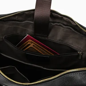 Detailed interior view of men leather briefcase showing multiple compartments and lining.