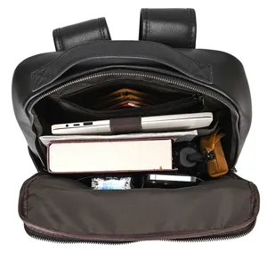Interior detail of black leather backpack showing spacious storage capacity and laptop compartment.