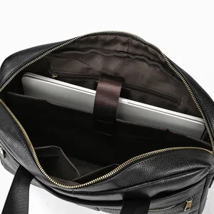 Detailed view of the black leather briefcase interior showing laptop compartment and multiple pockets.
