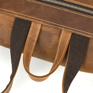 Close-up detail view of genuine leather backpack showing durable strap design with zipper.