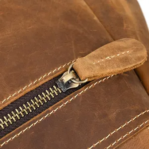 Close-up detail of vintage crazy horse leather backpack, premium metal zipper and fine stitching.