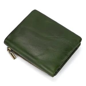 Dark green genuine leather wallet detail, showing soft cowhide texture and metal zipper.