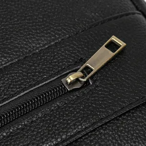 Close-up detail of mens black genuine leather business briefcase zipper and texture.