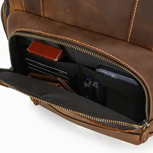 Close-up detail of genuine leather vintage backpack interior pocket with multi-slot organization.