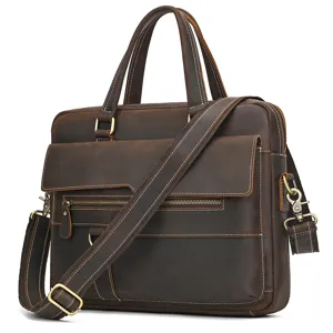 Close-up of genuine leather briefcase with metal zippers and adjustable shoulder strap.