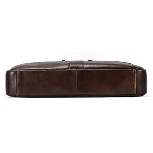 Detail view of brown genuine leather mens briefcase bottom with fine stitching work.