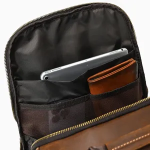 Men's genuine leather backpack interior detail shot, showing multi-pocket storage capacity.
