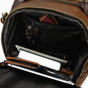 Leather backpack interior detail showing large capacity, multi-pocket design, and pen holders.