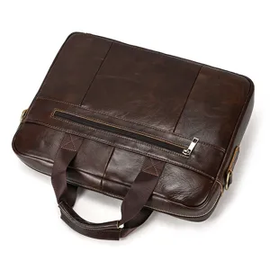 Close-up detail of the dark brown leather briefcase, showing premium stitching and zipper.