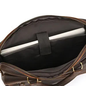 Vintage leather briefcase interior detail showcasing 15-inch laptop compartment and durable lining.