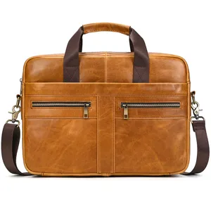 Detailed view of brown leather business briefcase with dual front zipper pockets and durable handles.