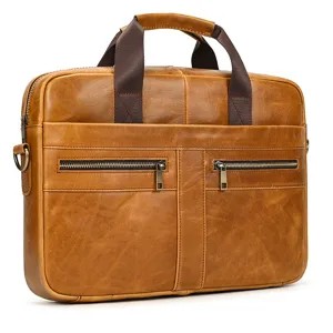 Men's brown leather laptop briefcase detail shot, showcasing premium cowhide texture and zippers.