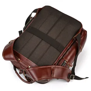 Detailed view of dark brown genuine leather vintage backpack featuring breathable mesh panel
