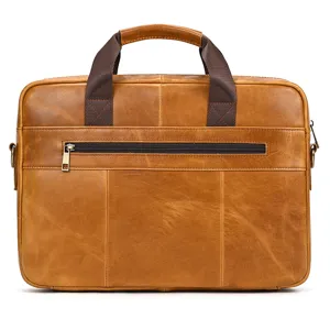 Close up detail of premium brown leather mens briefcase, showing smooth texture and metal zipper.