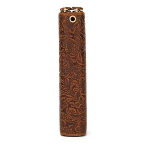 Close-up detail of vintage embossed leather long wallet showing intricate floral pattern.