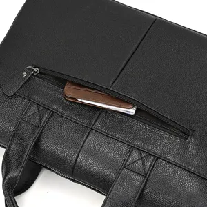 Detail shot of black leather men business briefcase showing textured surface and zipper pocket.