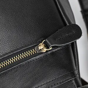 Genuine leather backpack detail view featuring durable metal zipper and fine stitching work.