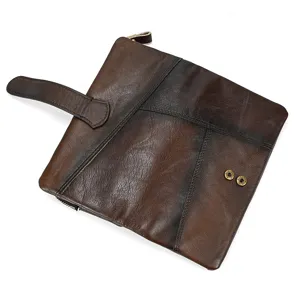 Vintage distressed leather long wallet with snap button and multiple card slots. Detail view.