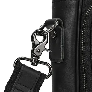 Men's leather briefcase hardware close up, black leather and metal clasp detail view