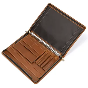 Detail view of brown leather A4 business file folder with metal ring binder and pen slots.