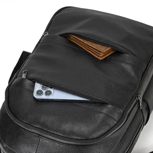 Dettaglio zaino in pelle nera con tasca frontale con zip per smartphone e portafoglio.