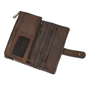 Detail view of vintage distressed leather long wallet with multiple card slots and zipper.