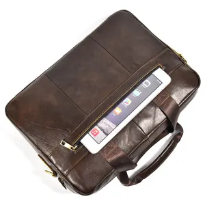 Close-up detail of dark brown leather business briefcase with front zipper pocket and tablet.