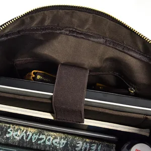 Men's leather laptop briefcase interior detail showing spacious compartments and secure laptop strap.