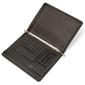 Detailed interior view of brown leather A4 binder portfolio featuring multiple card and pen slots.