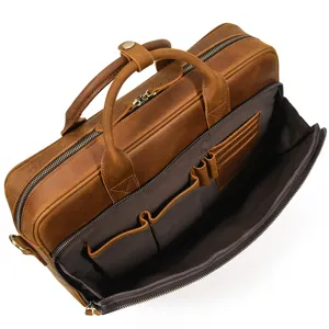 Men's brown leather briefcase interior detail, vintage laptop bag with multiple pockets.