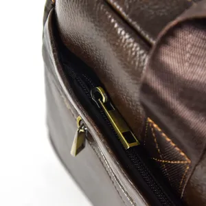 Men's leather briefcase detail shot, high quality cowhide texture and metal zipper.