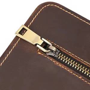 Close up detail shot of genuine crazy horse leather document bag zipper and stitching.
