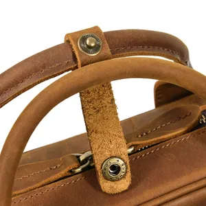 Detailed view of genuine crazy horse leather briefcase handle and metal snap hardware.