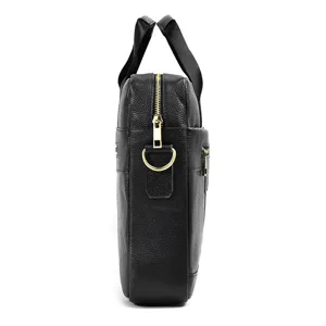 Side detail shot of black leather men business laptop briefcase with gold hardware and handles.