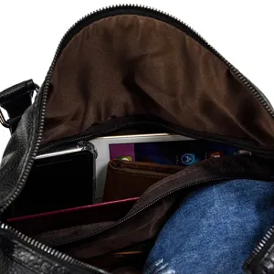 Interior detail view of black leather travel duffel bag showing spacious capacity and pockets.