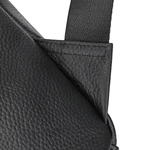 Men's leather business backpack strap detail closeup, premium cowhide, durable stitching.