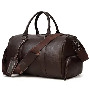 Detail view of men leather travel duffel bag with shoe compartment and sturdy shoulder strap.
