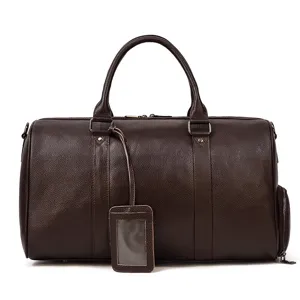 Detail view of the premium brown genuine leather travel duffel bag with sturdy handles.