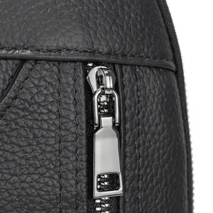 Close up detail of mens black genuine leather backpack zipper and texture hardware craftsmanship.