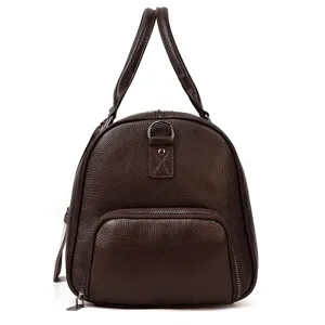 Detailed view of the genuine leather travel duffel bag showing fine texture and sturdy zipper.