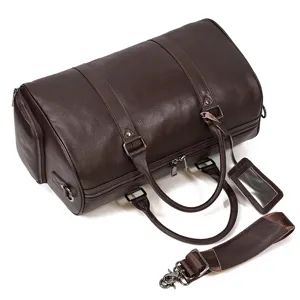 Detailed close-up of dark brown genuine leather travel duffel bag with reinforced handles.