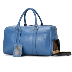 Men's genuine leather travel duffel bag detail showing the convenient side shoe compartment.