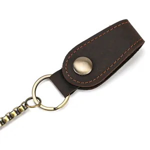 Detailed shot of vintage genuine leather wallet chain strap with brass hardware and snap button.