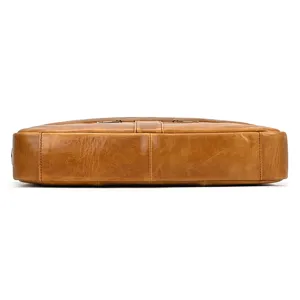 Men's genuine leather briefcase detail view showing bottom construction and fine leather texture.