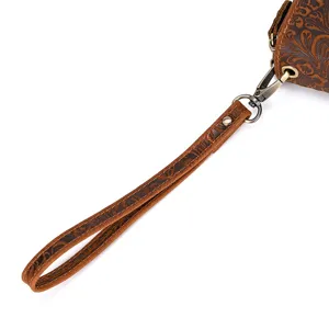 Detail view of brown embossed genuine leather men wallet wrist strap with vintage floral pattern.