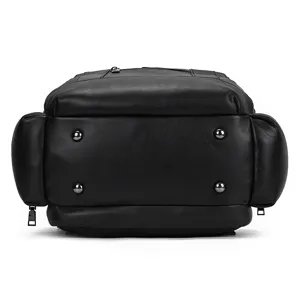 Men's genuine leather backpack bottom detail, black cowhide, multi-pocket design, durable metal feet.